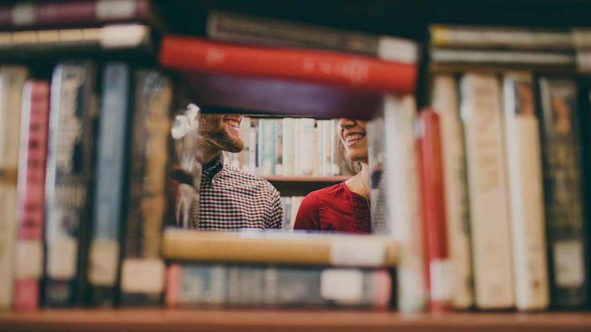Children reading books from a shelf, building vocabulary and reading skills