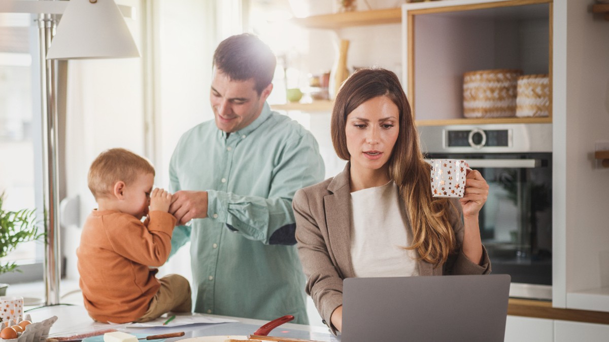 Family at home using a laptop together for an after-school online lesson
